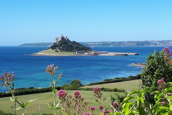 St. Michaels Mount surrounded by a blue sea on a bright sunny day